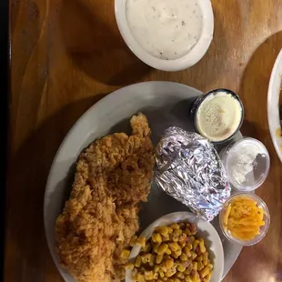 Chicken fried chicken , baked potato, corn , gravy on side
