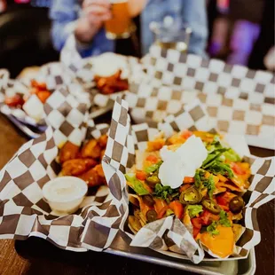 a plate of nachos and a glass of beer