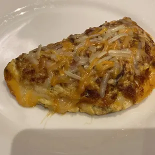 Omelette with bacon, ham, tomatoes, and extra cheese