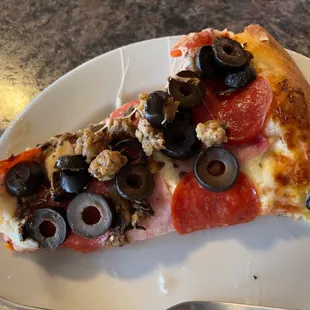 a slice of pizza on a plate