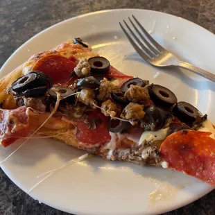 a slice of pizza on a plate