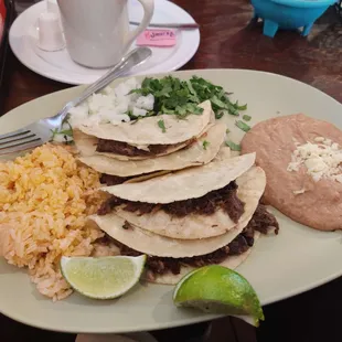 barbacoa tacos - arrived with lime, onion, cilantro, rice, and refried beans