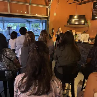 a group of people sitting at a bar