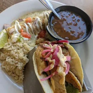 Fish taco and enchilada combo with cilantro lime rice and charro beans