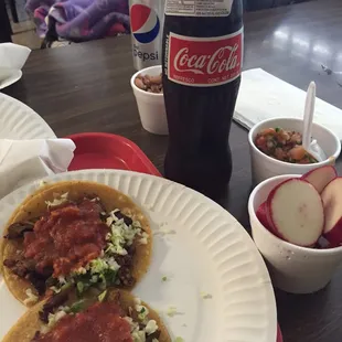 Two Al pastor tacos and a Mexican coke