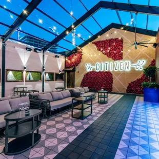 a lounge area with a bar and lounge chairs