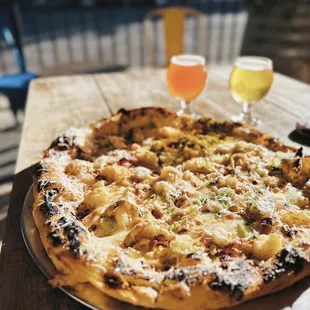 a pizza and a glass of beer