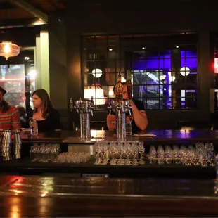 a bartender pouring a drink