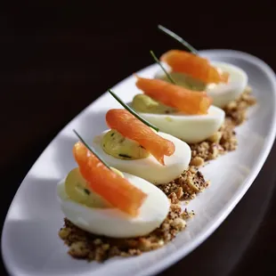 an appetizer of hard boiled eggs and salmon