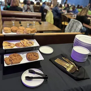 a table with plates of cookies and desserts
