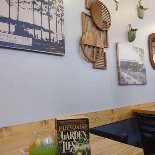 a table with a book and a drink