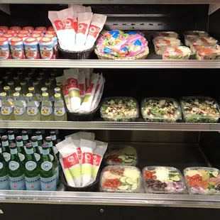Display case, with sodas and fresh salads.