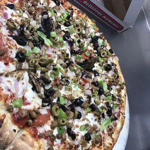 Supreme--pepperoni, hamburger, pork sausage, ham, mushrooms, onions, bell peppers, black olives and green olives.