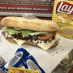 Chicken club sub--ham, bacon, grilled chicken, onions, tomatoes, lettuce and cheese