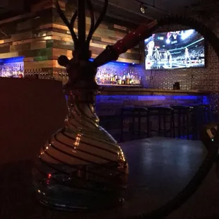 a glass vase with a hook hanging from it