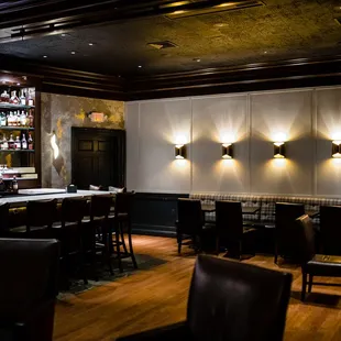 a bar with a lot of bottles on the wall