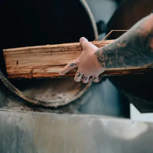 a man holding a piece of wood