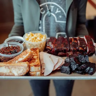 a person holding a tray of food