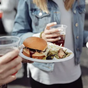 two people holding plates of food