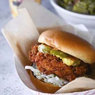 a chicken sandwich and a side of green beans