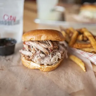 a pulled pork sandwich and fries