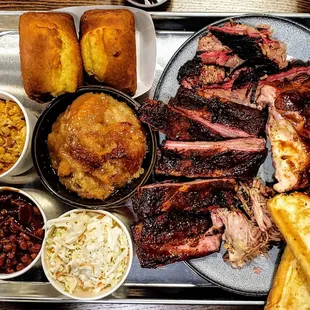 a tray of meat and sides