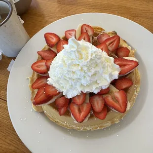 Belgian waffle w banana and strawberries topped with whip