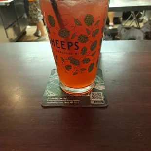 a glass of beer on a coaster