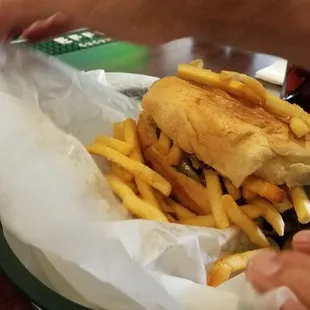 a sandwich and french fries in a basket