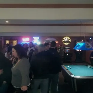 a group of people playing a game of pool