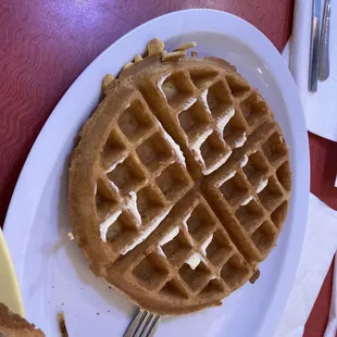a waffle on a plate with a fork