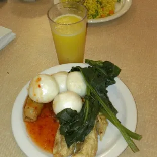 Barbeque pork bun, egg rolls, pot stickers, and Chinese broccoli. All covered with sweet chili sauce.