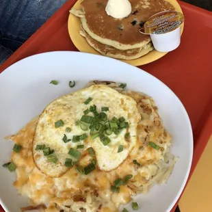 Create your own skillet with hashbrowns, cheese, and eggs over easy and a side of blueberry pancakes