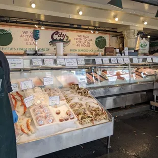 a man standing in front of a display of seafood