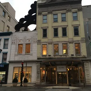 Front of the building, from across the street. White building houses the gallery.