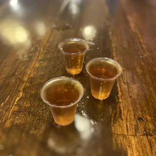 three cups of tea on a wooden table