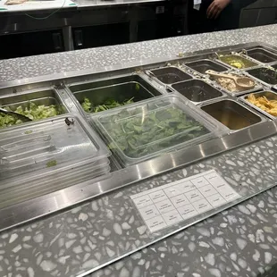 a salad bar with a variety of salads