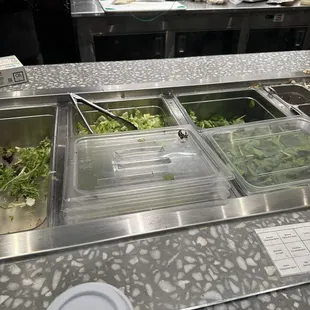 a salad bar with a variety of salads