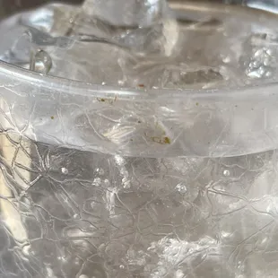 Dirty glass with a floater inside.