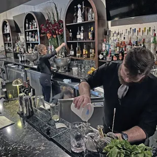 a bartender pouring a drink