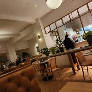 people sitting at tables in a restaurant