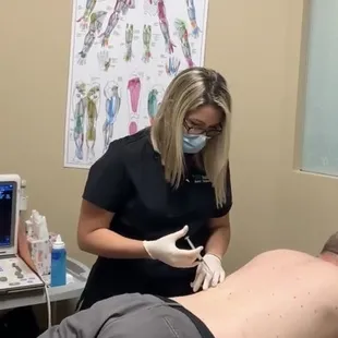 Chelsea giving injection treatment to a patient for back pain in our Phoenix office