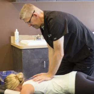 Dr.Jex giving an adjustment at the Phoenix office