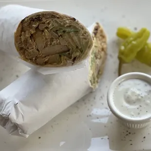 Wrap Tender marinated chicken, slow-cooked and thinly sliced. with Salad, Hummus &amp; Sauce Inside.