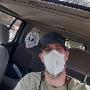 a man wearing a mask in a car