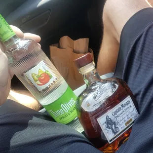 a man holding a bottle of liquor