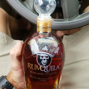 a man holding a bottle of rum