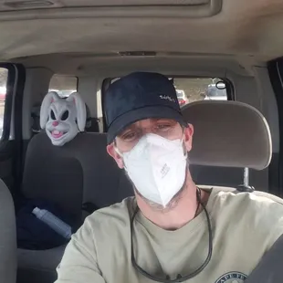 a man wearing a mask in a car