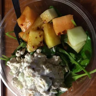 Chicken salad on a bed of spinach and fruits, spicy sesame dressing, and a free side of bread and butter. All for less than $7
