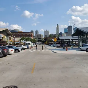 a man walking across a parking lot